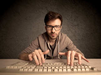 Computer geek typing on keyboard