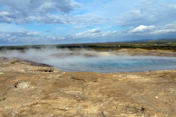 Iceland landscape. Steaming geothermal sources water. Famous geologic features and natural phenomena