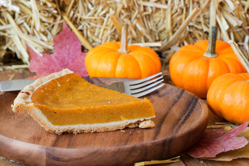 Slice of Pumpkin Pie on a Wooden Plate