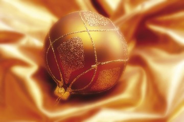 Golden Christmas decoration ball on satin cloth
