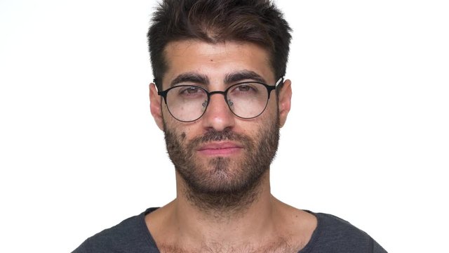 hispanic bearded guy in glasses with chest hair under grey t-shirt nodding positively being glad looking smart over white background. Concept of emotions