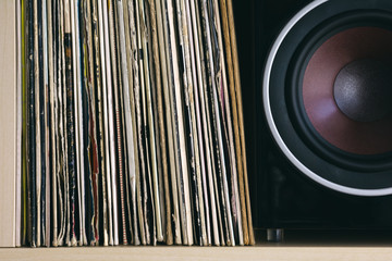 Old vinyls next to a loudspeaker