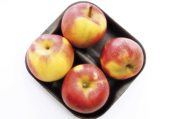 Red apples in plastic tray packaging