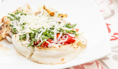 Cuttlefish with tomato, salad and Parmigiano cheese