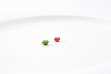 Two pills on an otherwise empty white plate: symbol for the dieting craze