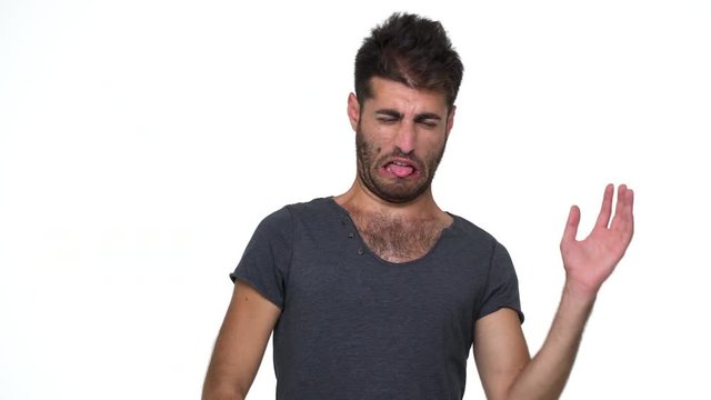 skinny young man wearing grey t-shirt pinching nose with disgust on his face  due to bad smell something stinking need fresh air over white background. Concept of emotions