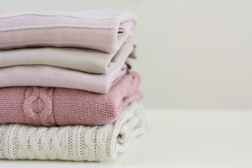Stack of warm pastel sweaters