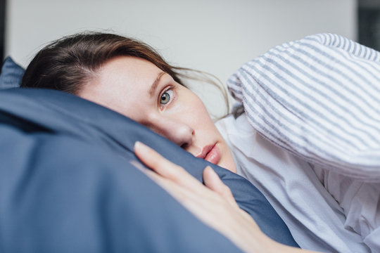 Portrait of a woman in bed in the morning