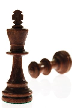 Checkmate: king and toppled queen chess pieces