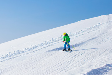 Fototapeta na wymiar Ski and snow fun for kids in winter mountains