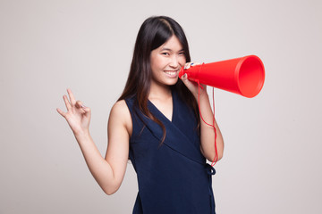 Beautiful young Asian woman show OK  announce with megaphone.