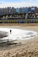 A Silhouetted Person walking on the Beach