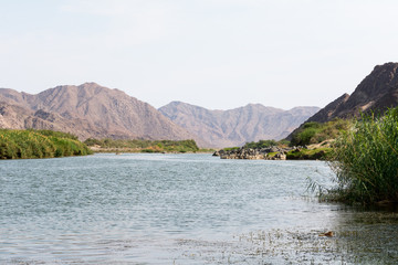 view on the oranje river in namibia, africa. the oranje river is the longest river in south africa and builds the border of namibia and south africa.