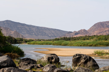 view on the oranje river in namibia, africa. the oranje river is the longest river in south africa and builds the border of namibia and south africa.