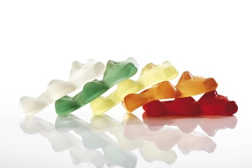 Multicoloured gummi bears, tilted in a row