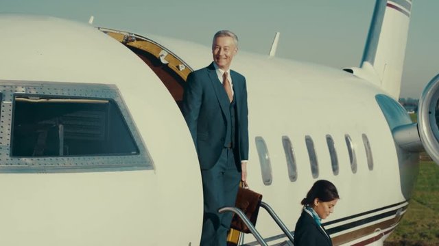  VIP Businessman or public figure disembarking from private jet & waving