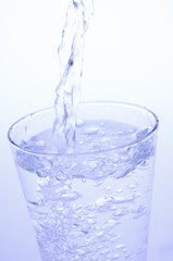Pouring mineral water into a glass