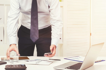 Close up of a businessman with phone and water