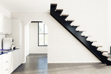 White brick kitchen, black stairs