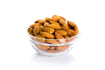 Group of almonds placed in a bowl on a white background