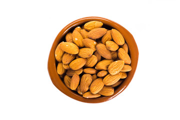 Group of almonds placed in a bowl on a white background
