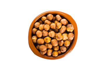 Group of peeled hazelnuts in a bowl on a white background