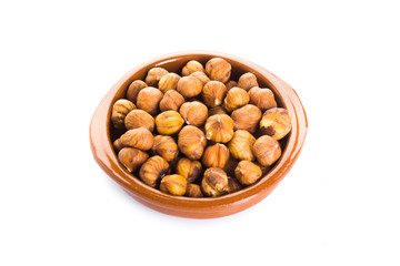 Group of peeled hazelnuts in a bowl on a white background