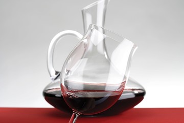 Naklejka na ściany i meble Decanter and wine glass filled with red wine