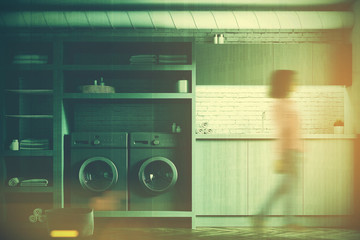 White laundry room, gray washing machines, girl