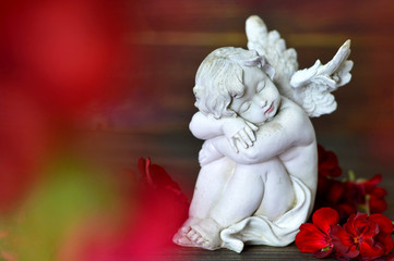 Condolence card with little guardian angel and funeral flowers