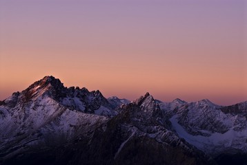Fototapeta premium Sunrise with violet-coloured sky and snow-covered mountains, Namlos, Reutte, Tyrol, Austria, Europe
