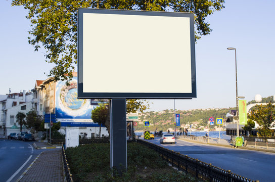 horizontal blank billboard on the city street in background buildings and road with cars mock up