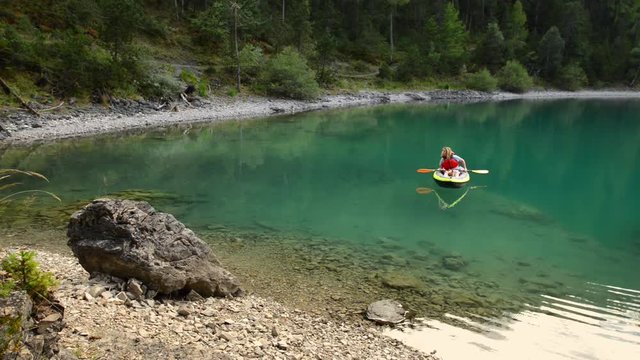 Kayaking on the Blindsee Lake, Austria. Woman with Small Dog on the Trip