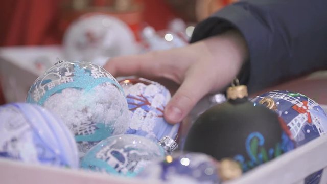 Close-up of New Year theme man's hand taking glass bowl with patten and slowly rotate it