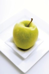 Green apple on a plate