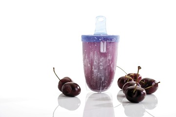 Home made popsicle or ice lolly, mould and fresh cherries