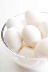 White eggs in a glass bowl