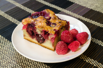 Cherry sponge cake with berries fresh raspberries