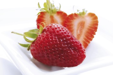 Fresh whole and halved strawberries