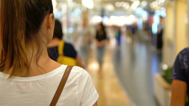 Young Woman Exploring Modern Shopping Mall In Slowmotion