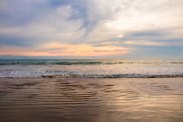 Fototapeta premium Sunset in Mexico with a beach and ocean. 