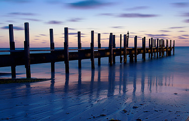 Sunset with pier and reflections