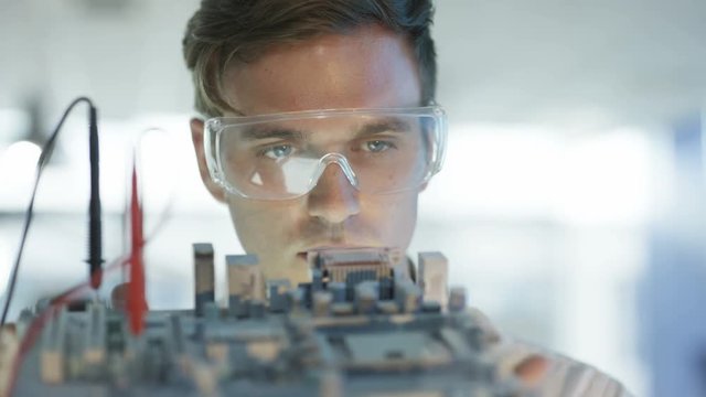  Close up electronics engineer working in lab building & testing motherboard. 