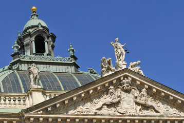 Fototapeta na wymiar Lady Justice, Innocence and Vice on the palace of justice, south front and dome, Munich, Bavaria, Germany, Europe