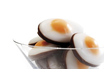 Fried egg candies made of fondant in a cocktail glass