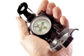 Hand holding a compass