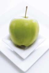 Green apple on small plate