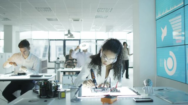  Technicians working in modern lab building electronics & robotics