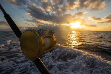 Deep Sea Fishing Reel on a boat during sunrise