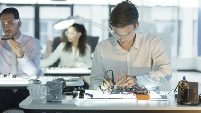  Close up electronics engineer working in lab building & testing motherboard. 
